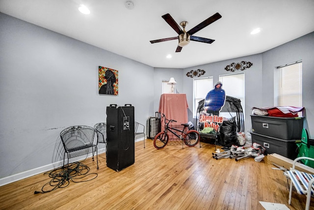 misc room with hardwood / wood-style flooring and ceiling fan