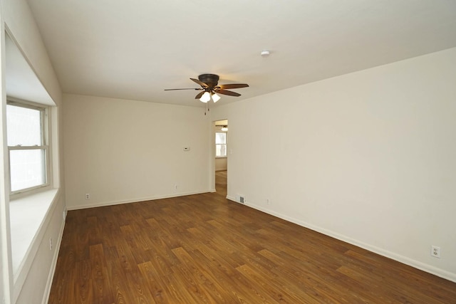 spare room with ceiling fan and dark wood-type flooring