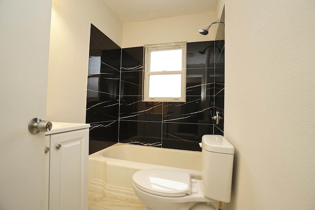 full bathroom featuring vanity, tiled shower / bath combo, and toilet