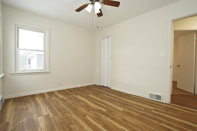 empty room featuring hardwood / wood-style flooring and ceiling fan