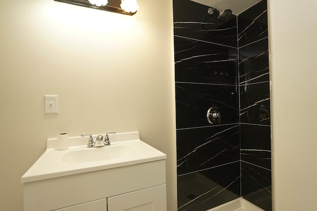 bathroom featuring vanity and tiled shower