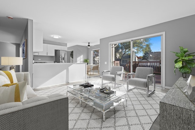 living room with light hardwood / wood-style flooring and ceiling fan