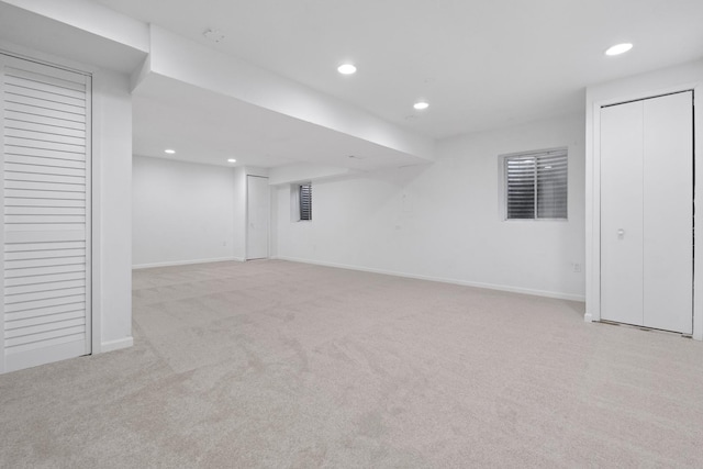 basement featuring light colored carpet