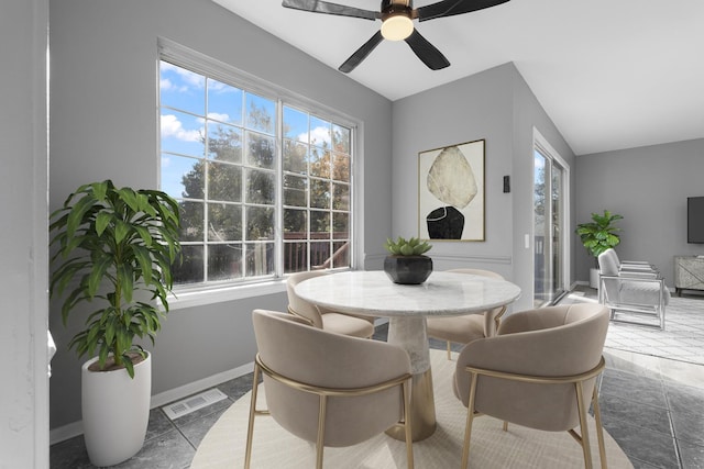 dining space featuring ceiling fan, plenty of natural light, and tile patterned flooring