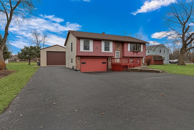 bi-level home with a garage and a front lawn