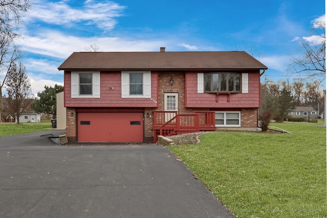 split foyer home featuring a garage and a front lawn