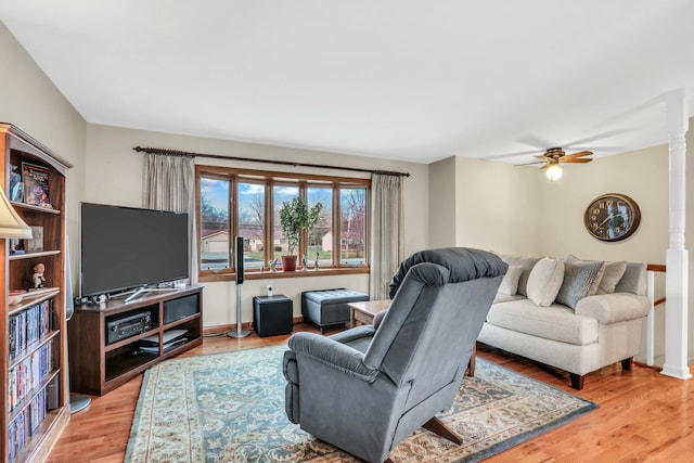 living room with hardwood / wood-style flooring and ceiling fan