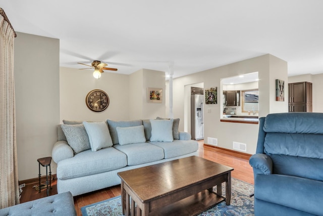 living room with ceiling fan and wood-type flooring