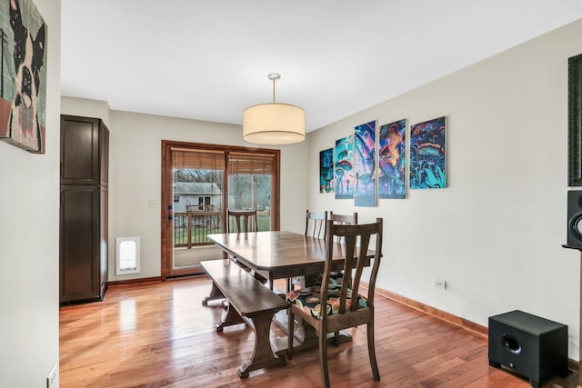 dining space featuring light wood-type flooring