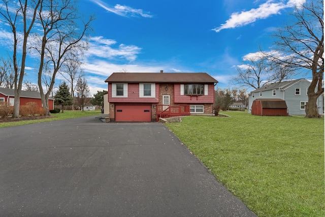 bi-level home with a front yard and a garage