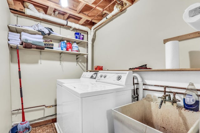 laundry area featuring separate washer and dryer and sink