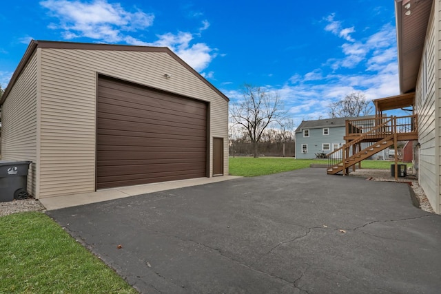 garage featuring a lawn and central AC