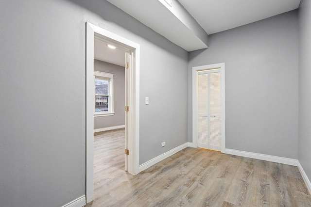 empty room with light hardwood / wood-style flooring