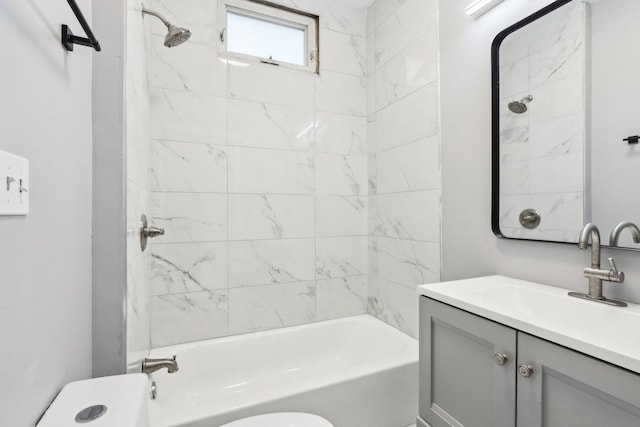 full bathroom featuring vanity, toilet, and tiled shower / bath