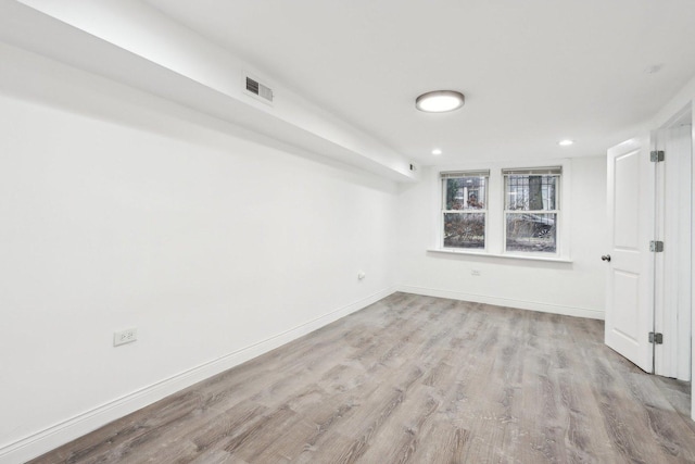 unfurnished room with light hardwood / wood-style floors