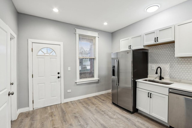 kitchen featuring white cabinets, stainless steel appliances, and sink