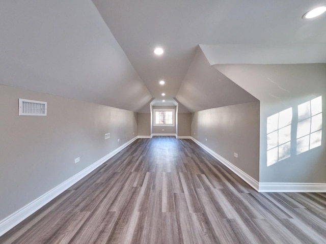 bonus room with hardwood / wood-style flooring and lofted ceiling