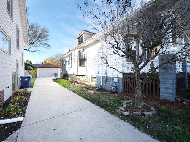 view of side of property featuring a garage and an outdoor structure