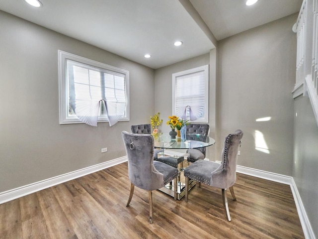 dining space with plenty of natural light and hardwood / wood-style flooring