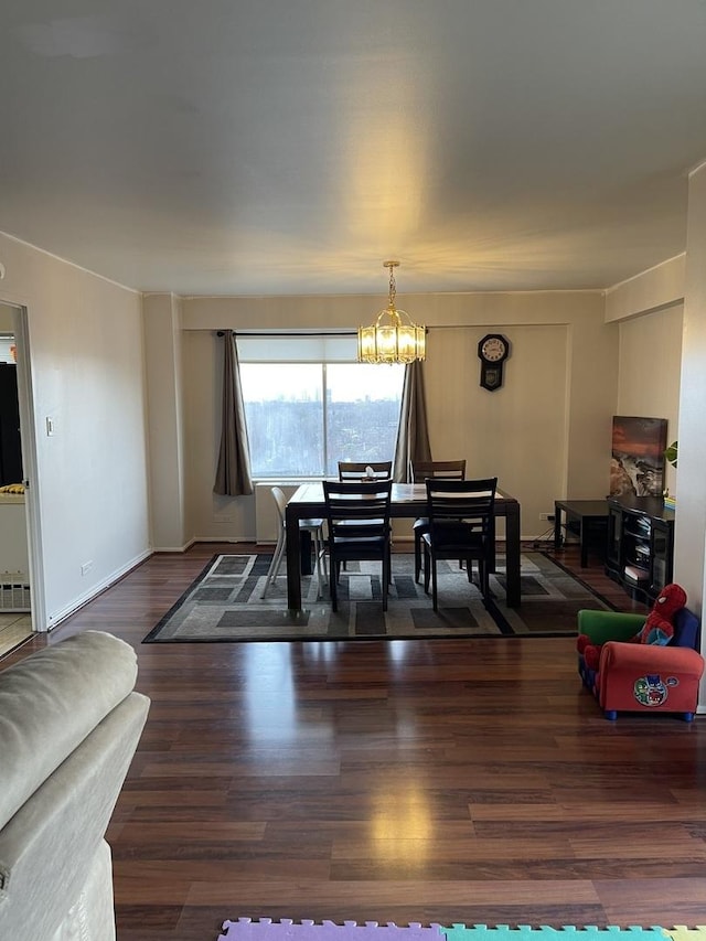 dining area featuring a notable chandelier and dark hardwood / wood-style floors