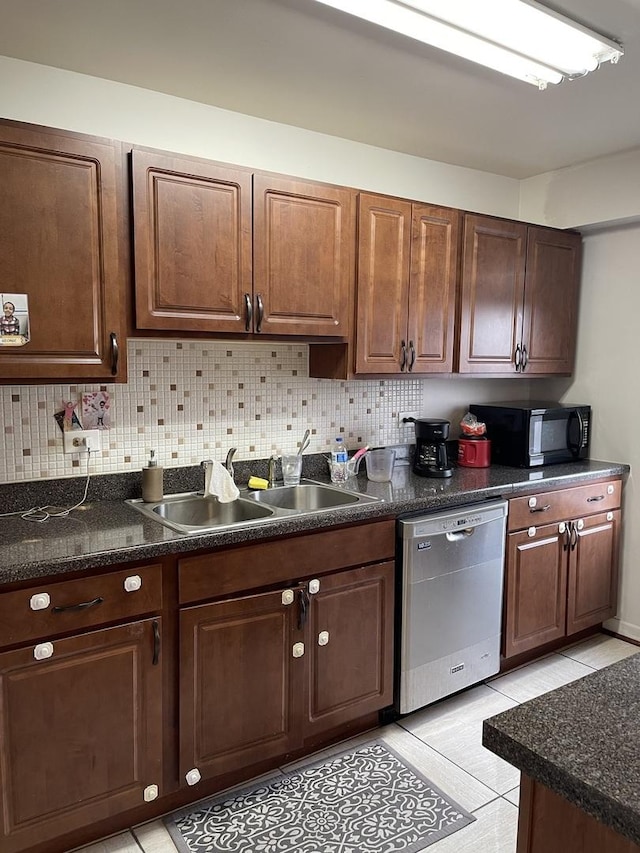 kitchen with dark brown cabinetry, sink, tasteful backsplash, stainless steel dishwasher, and light tile patterned floors