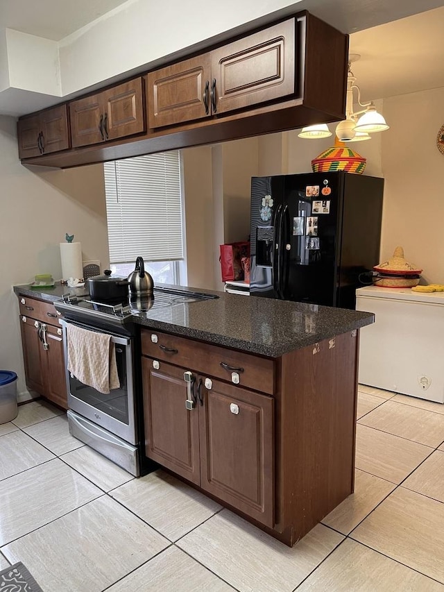 kitchen featuring pendant lighting, stainless steel range with electric cooktop, black refrigerator with ice dispenser, dark brown cabinets, and kitchen peninsula