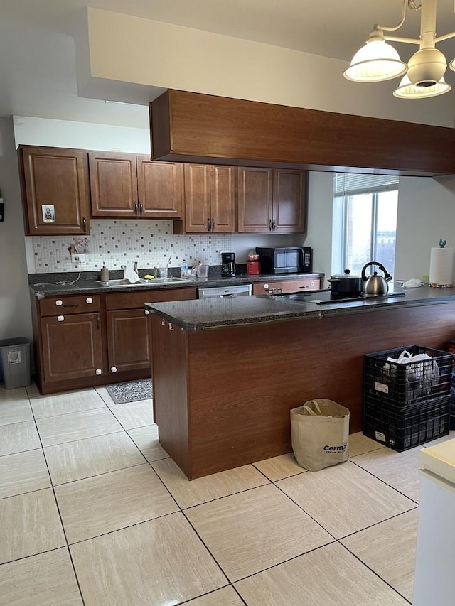 kitchen with pendant lighting, dark brown cabinetry, an inviting chandelier, and black appliances