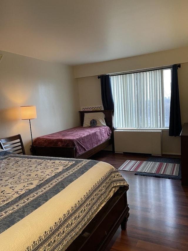 bedroom featuring dark hardwood / wood-style flooring and billiards