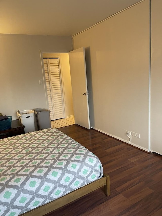 unfurnished bedroom featuring hardwood / wood-style flooring and a closet