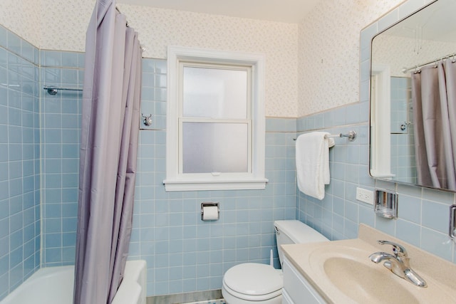 full bathroom featuring tile walls, shower / bathtub combination with curtain, toilet, and vanity