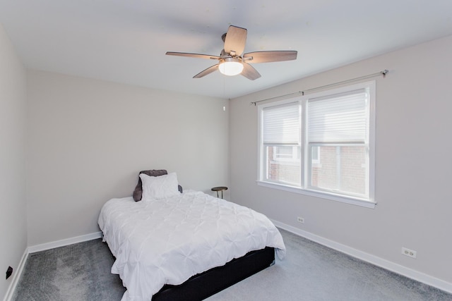 bedroom with ceiling fan and dark carpet