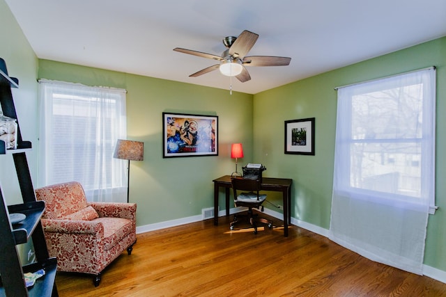 home office featuring hardwood / wood-style floors and ceiling fan