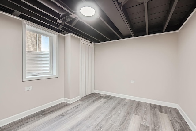 basement with light hardwood / wood-style floors