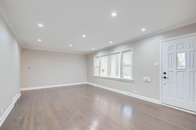 foyer entrance with dark hardwood / wood-style floors and ornamental molding