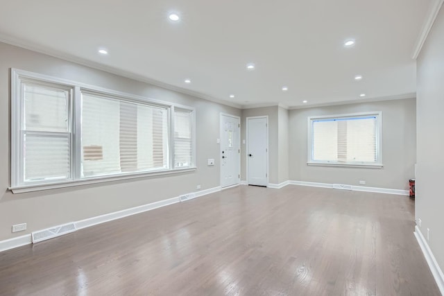 interior space featuring crown molding and wood-type flooring