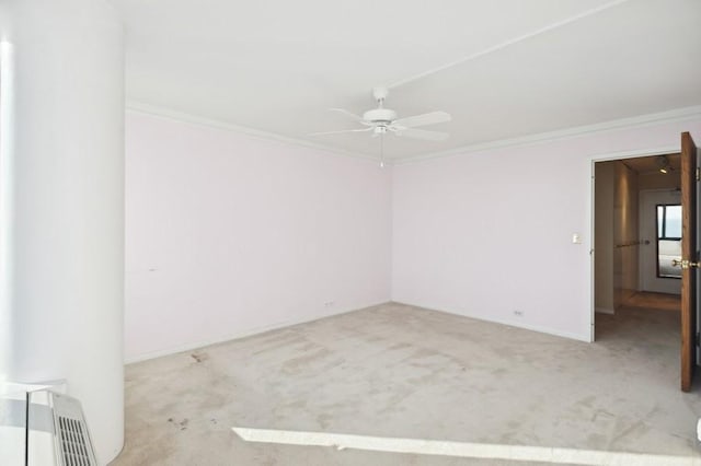 carpeted empty room with ceiling fan and ornamental molding