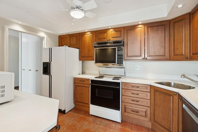 kitchen featuring ceiling fan, sink, light tile patterned floors, and white appliances