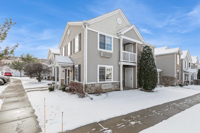 view of snow covered exterior with a balcony