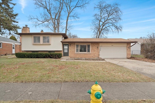 tri-level home with a garage and a front lawn