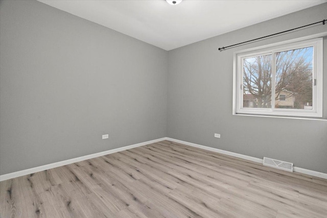 spare room with light wood-type flooring