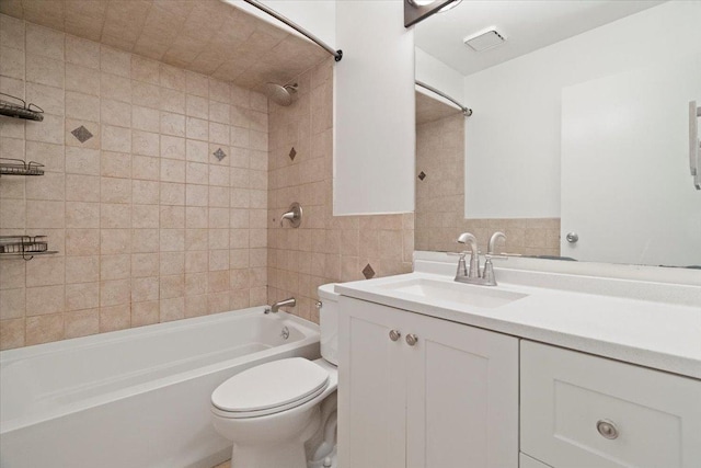 full bathroom featuring vanity, toilet, and tiled shower / bath