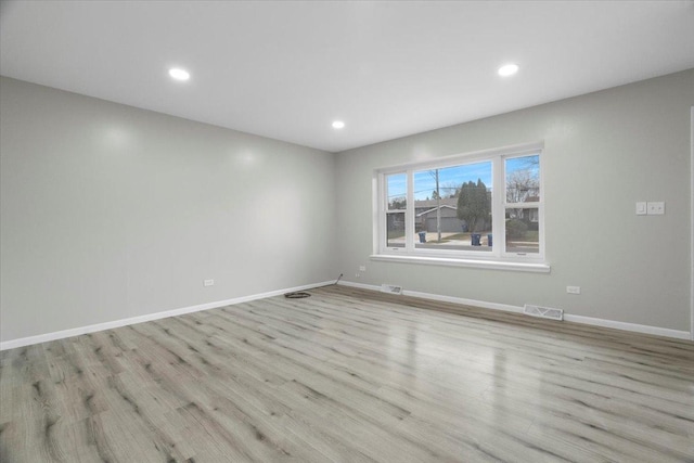 unfurnished room with light wood-type flooring