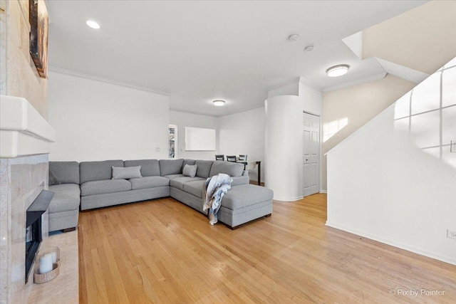 living room with hardwood / wood-style flooring and crown molding