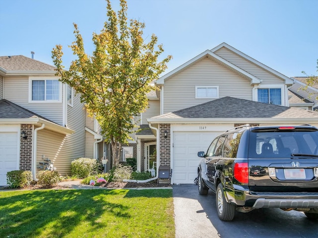 view of front of house with a front yard and a garage