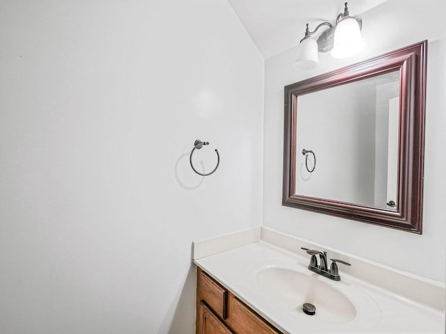 bathroom featuring vanity and vaulted ceiling