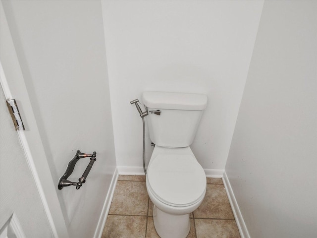 bathroom featuring tile patterned flooring and toilet