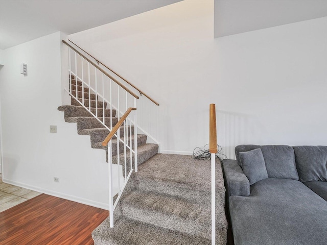 staircase featuring wood-type flooring