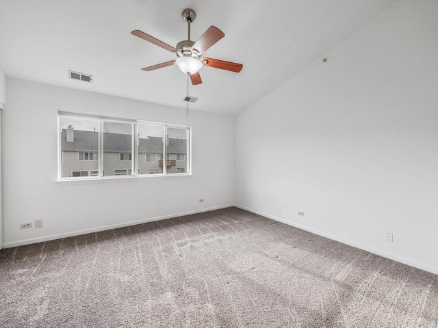 unfurnished room featuring lofted ceiling, ceiling fan, and carpet floors