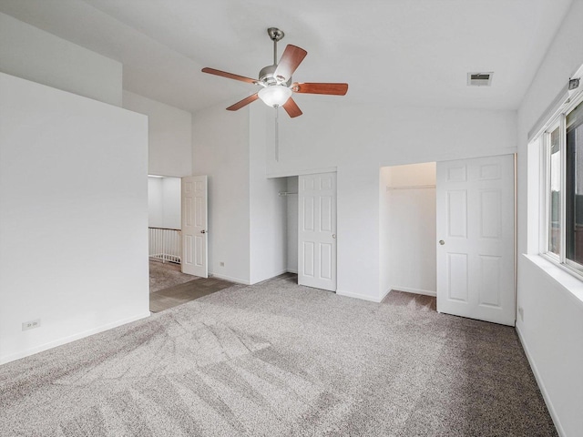 unfurnished bedroom featuring ceiling fan, light colored carpet, and vaulted ceiling