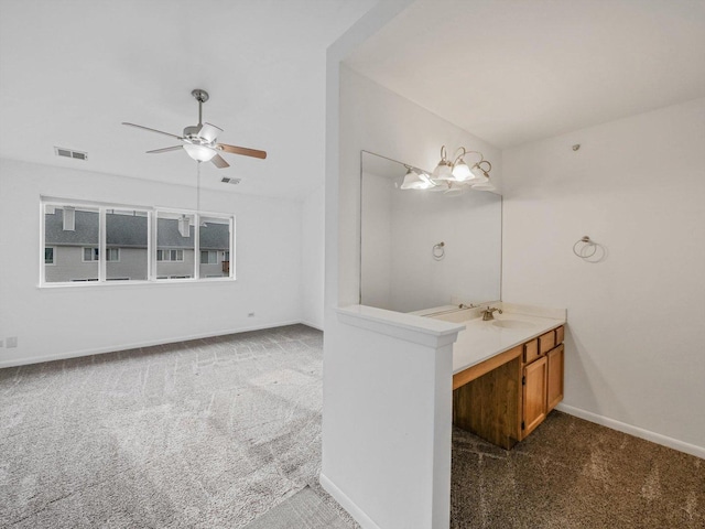 bathroom with vanity and ceiling fan with notable chandelier